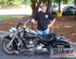 Man standing next to black custom motorcycle by bikez.com website