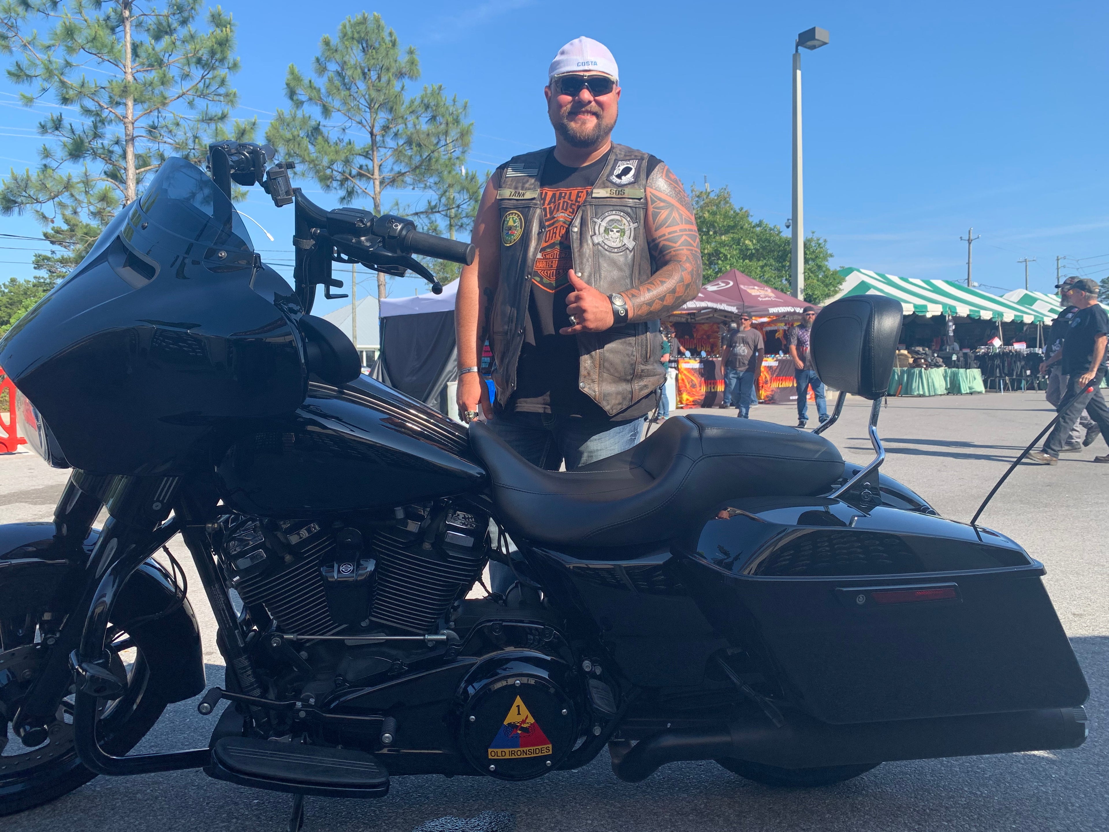 Man standing behind black motorcycle with custom timing color