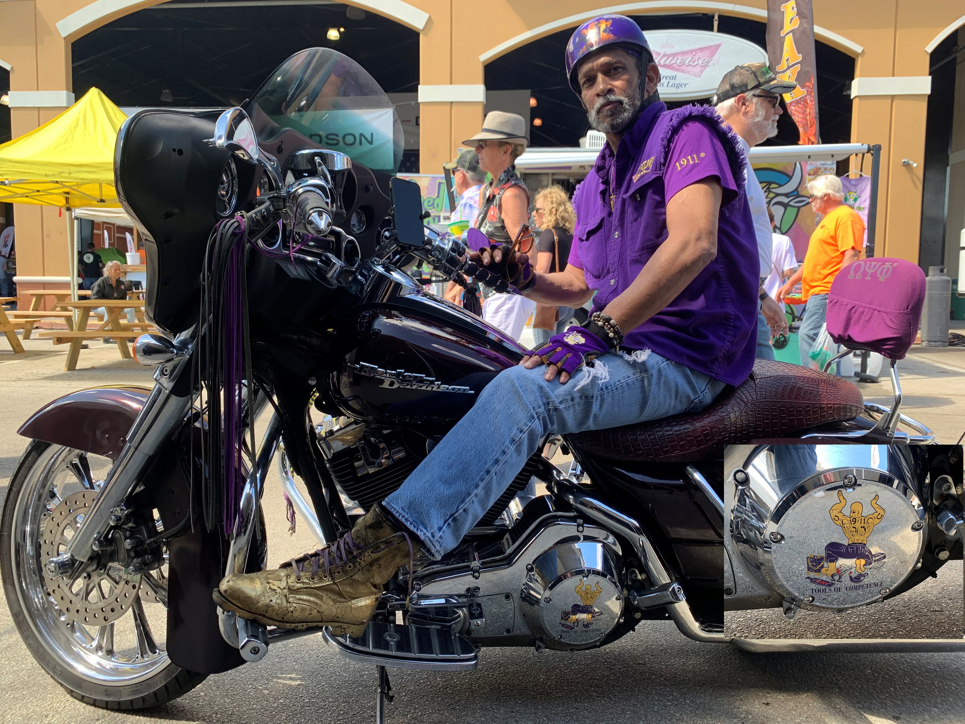 man wearing purple on black and purple motorcycle